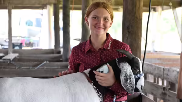a girl with her goat