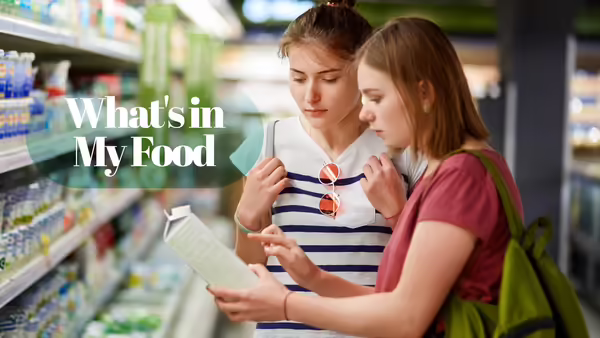 two women in grocery store reading a food label