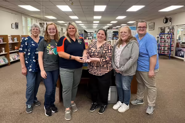 Kate Harding and 4-H Federation Member Anna Cloninger presenting Carlinville Public Library staff with the 2026 Community Partner Award for Macoupin County. 