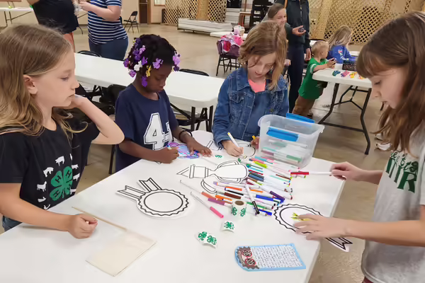 A group of young Cloverbuds work on art projects as part of the Cloverbud Showcase.