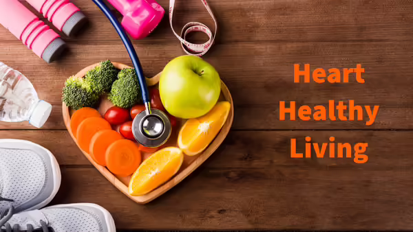 Heart shaped bowl of fruit and vegetables with stethoscope, hand weights and tennis shoes