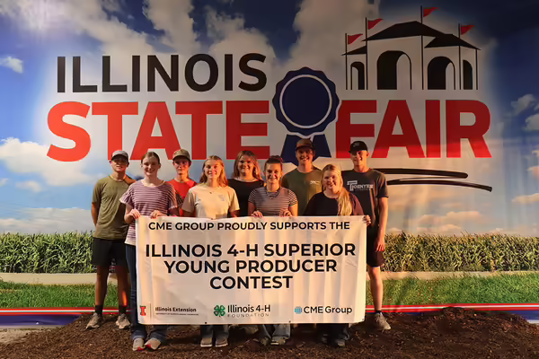 9 youth standing behind a banner for "Illinois 4-H Superior Young Producer Contest"