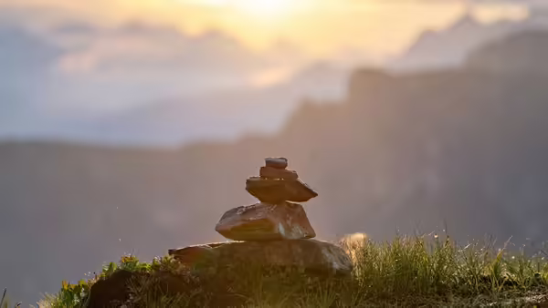 Rocks stacked with view of mountains and sky in the background