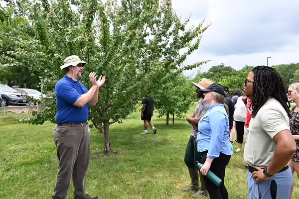 Dr. John Fisher teaching in an orchard