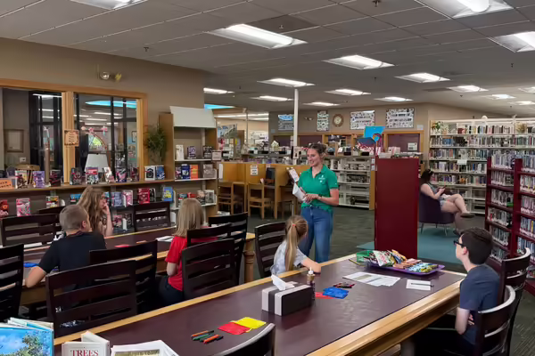 Lilliana Bernabei teaching a class in a library.