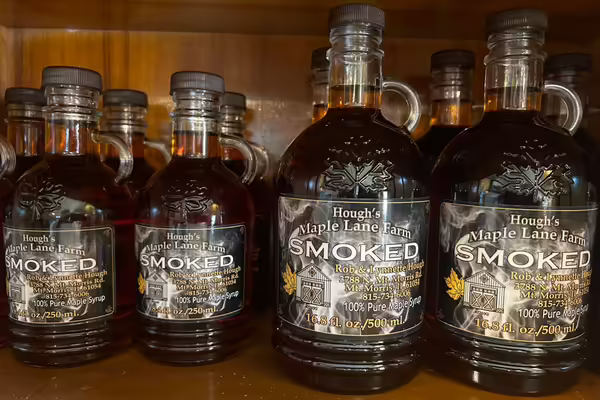 jugs of maple syrup on a shelf
