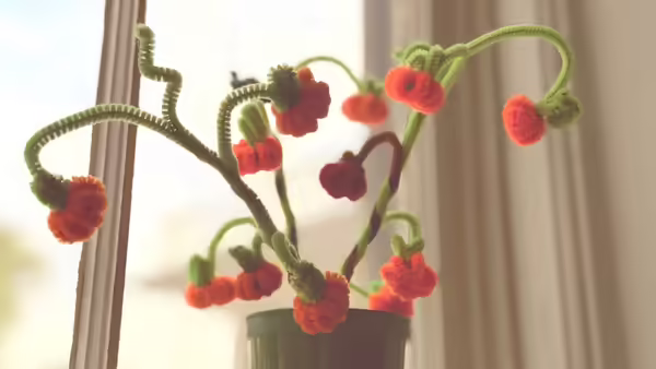 a pumpkin bouquet made out of orange and green pipe cleaners
