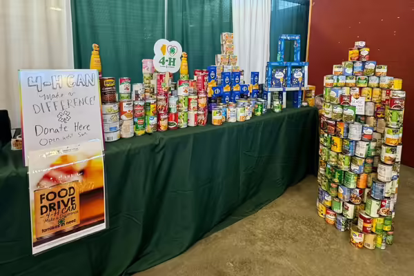 Cans stacked decoratively at the food drive booth.