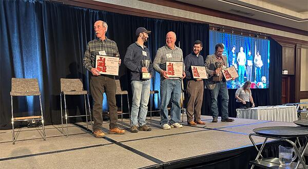 men standing on stage receiving awards for top cider making in Illinois