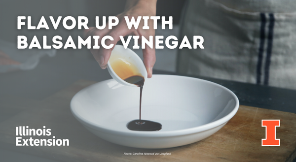 A person's hand is shown pouring balsamic vinegar into a white bowl.