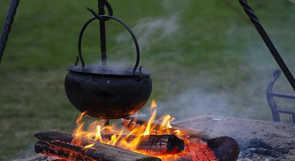 Cast iron pot hanging over campfire