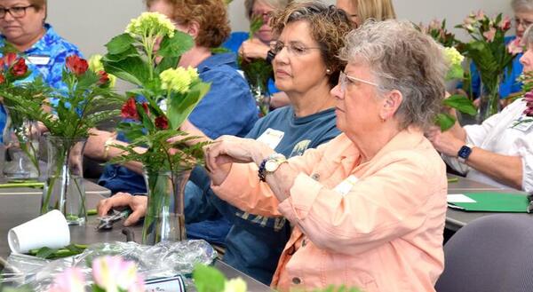 Participants learn how to make a floral arrangement