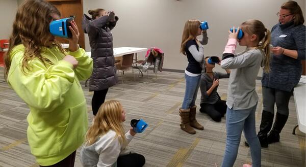 girls using virtual reality goggles