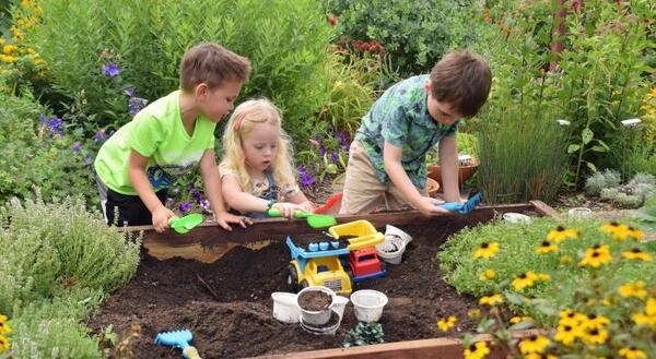 Children playing while learning about gardening
