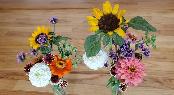 Two colorful bouquets on a wood table