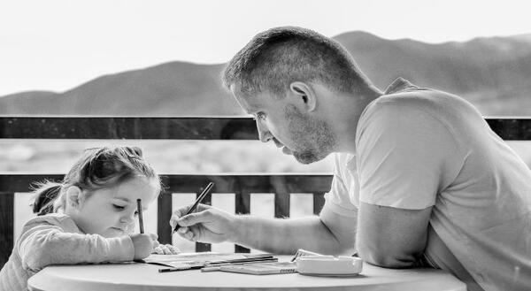 father with child writing