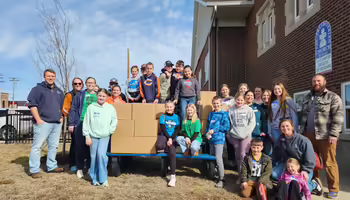 4 H members and their families after meal packing event
