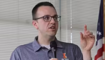 person talking and holding a microphone