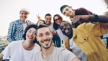 Group of people smiling and posing for a picture