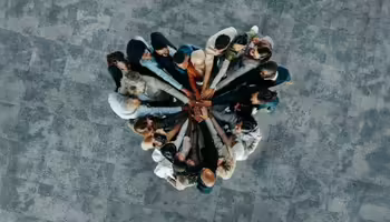 A group of people forming a heart