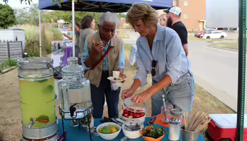 Master Gardener volunteer crafting botanical beverages at an event for guests