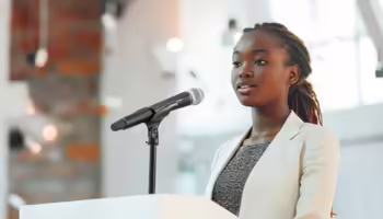teen standing in front of microphone