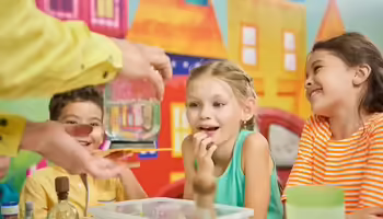 Smiling children looking at teacher