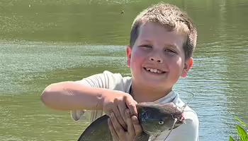boy holding a fish
