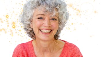 smiling older woman with sparkles behind her head
