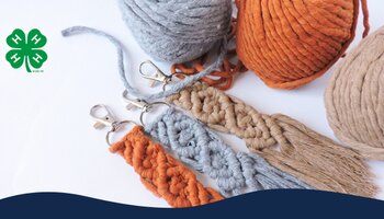 Orange, gray, and tan macramé key chains with balls of yarn next to the keychains.