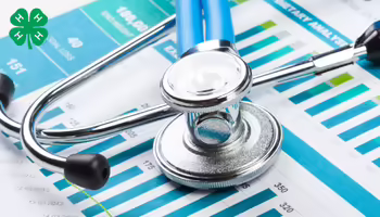 A stethoscope resting on top of medical charts and bar graphs featuring a green 4-H logo in the upper left corner.