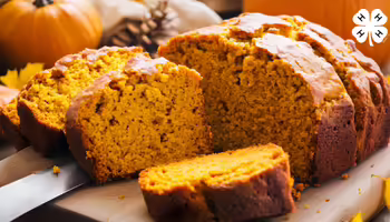 Sliced loaf of pumpkin bread on a cutting board, surrounded by whole pumpkins, pinecones, and autumn leaves, with a 4-H logo in the top right corner.