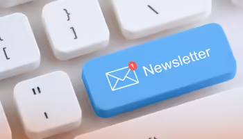 A white keyboard with a blue button that reads newsletter.
