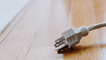 3 prong plug in on wooden floor