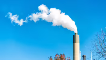 A smoke stack against a blue sky