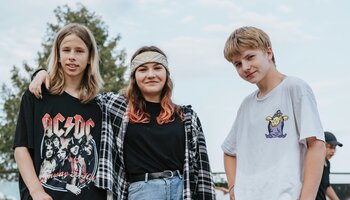 group of three teens smiling