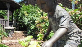 Statue of a child in a garden