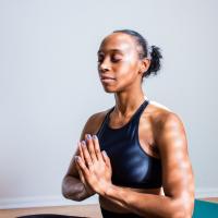 Woman with hands in front of heart meditating