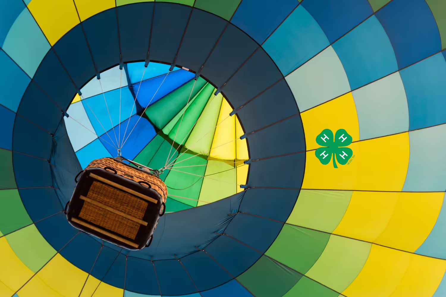 view up inside a hot air balloon that is blue, yellow and green