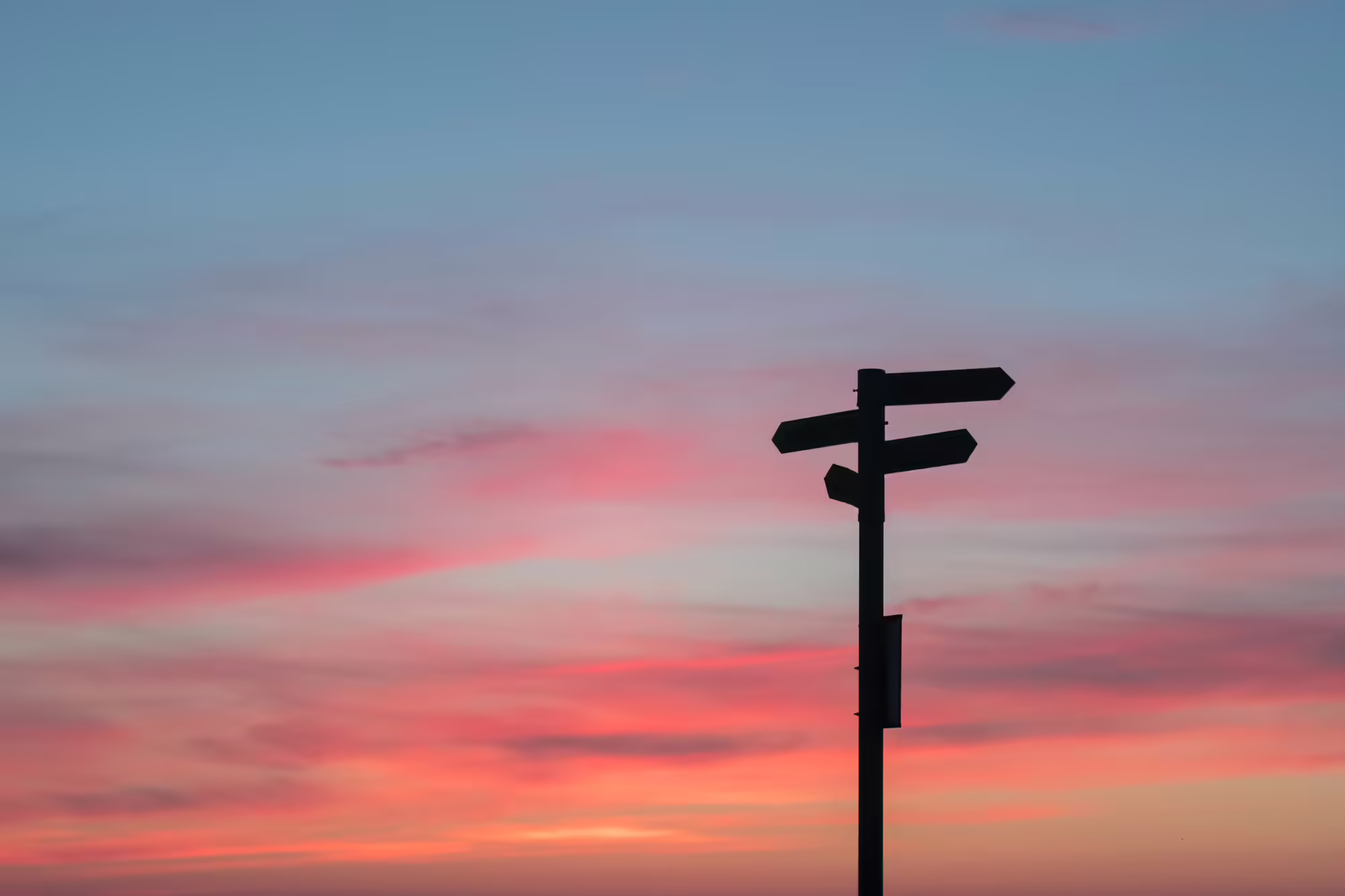 Sunny sky with directional signs.
