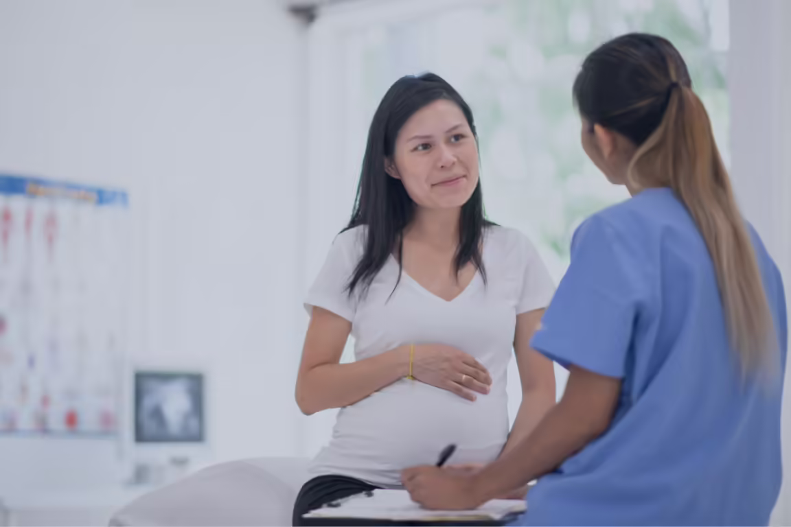 Pregnant woman talking with a healthcare person