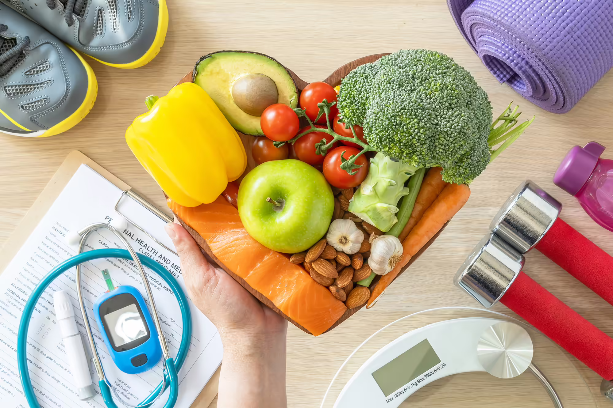 healthy food with exercise weights and shoes and heart monitor