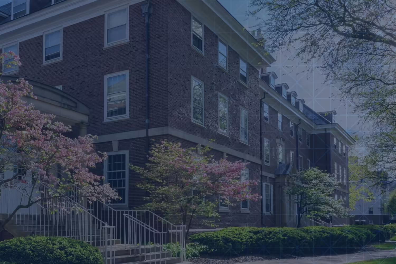 A building on campus with trees in bloom in the spring