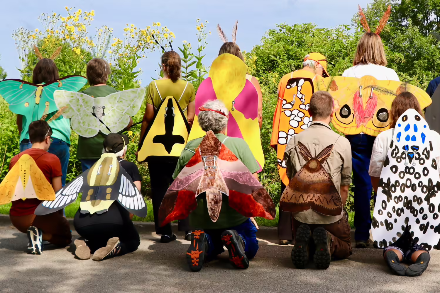 people wearing crafted moth wings