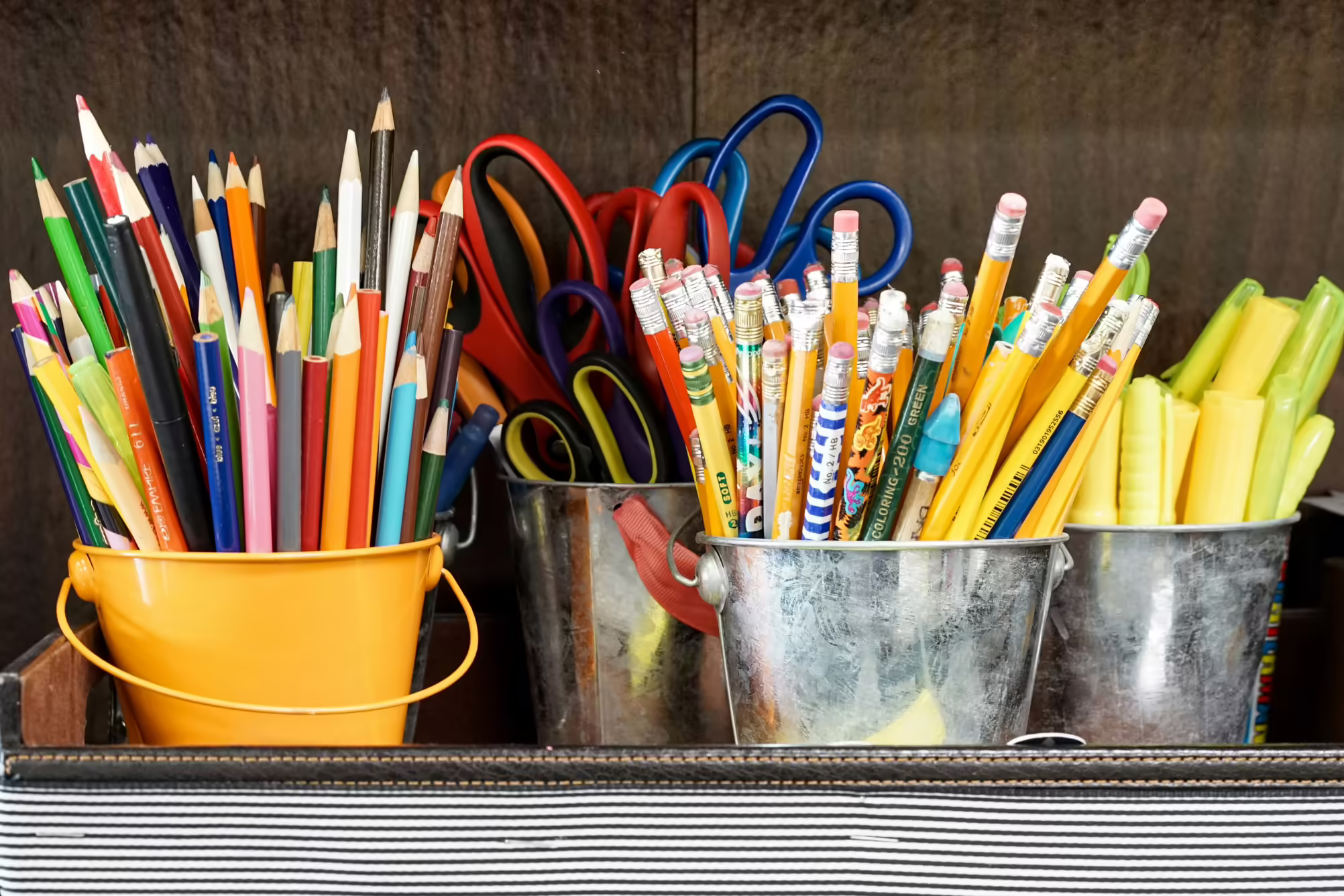pencils, scisors, markers in buckets