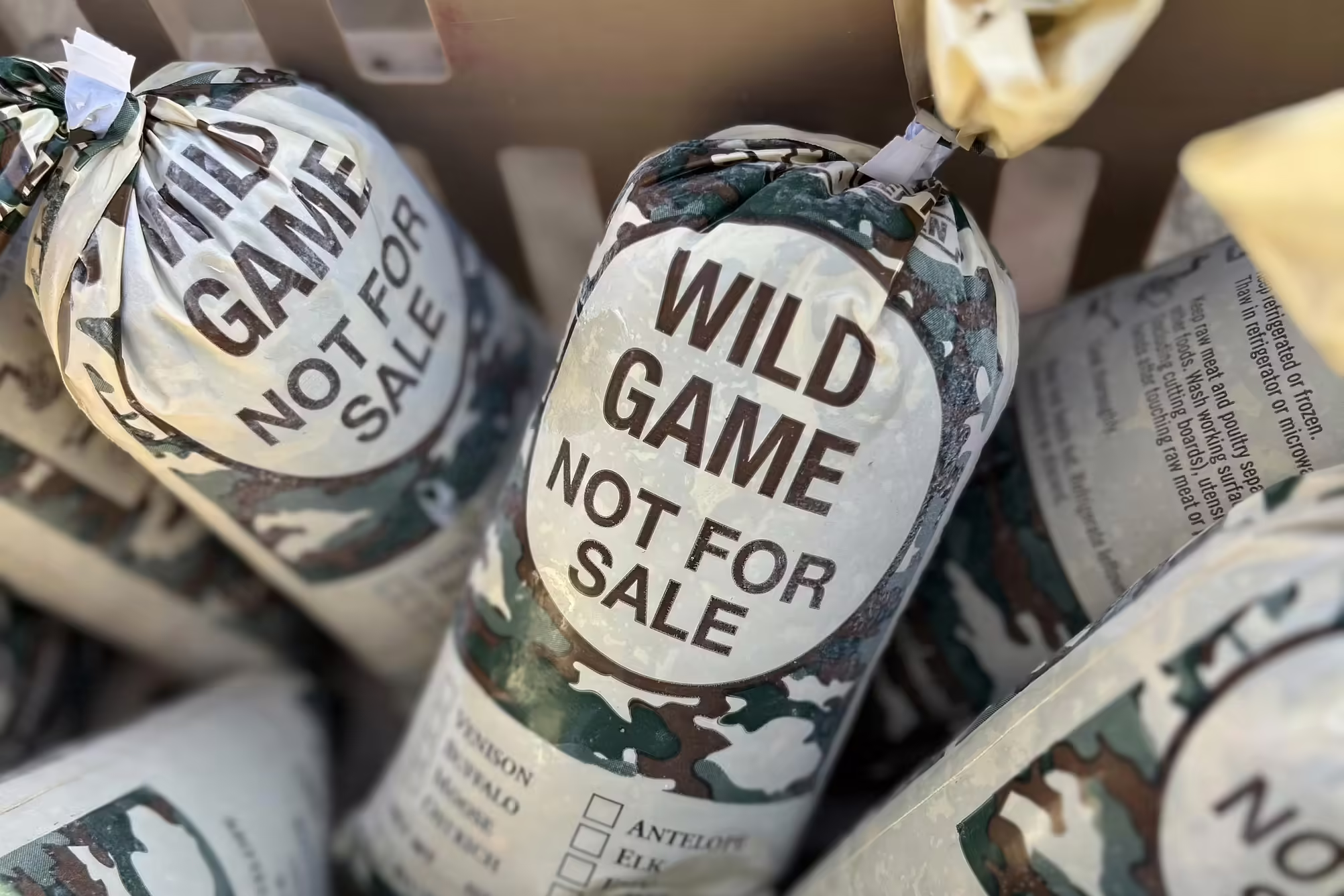 A close-up of packages of frozen ground venison that say "wild game, not for sale"