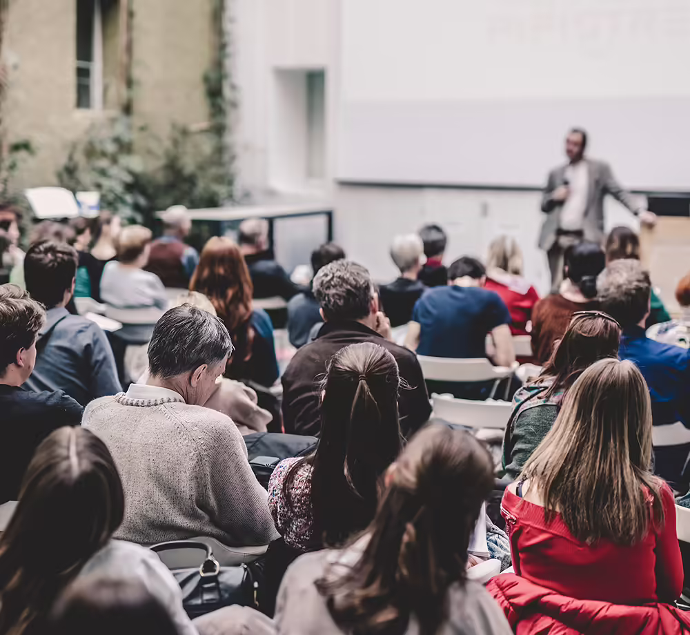 Speaker presenting to a room of people