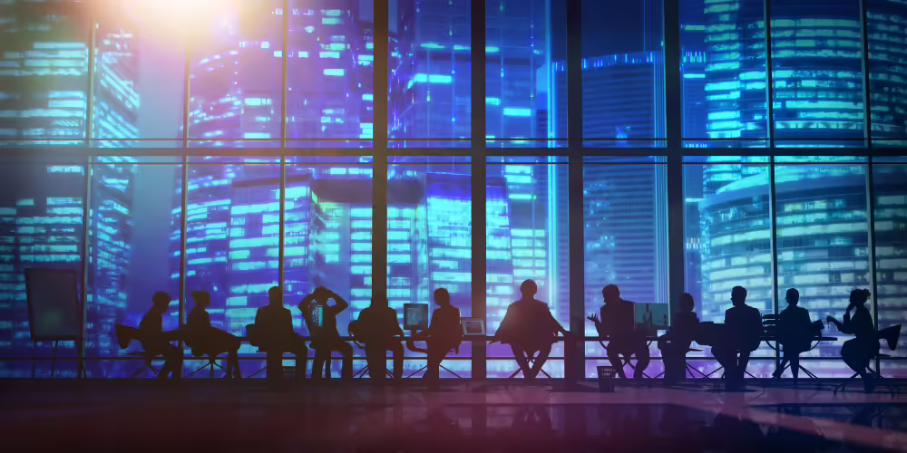 silhouettes of people in front of window with blue city skyline