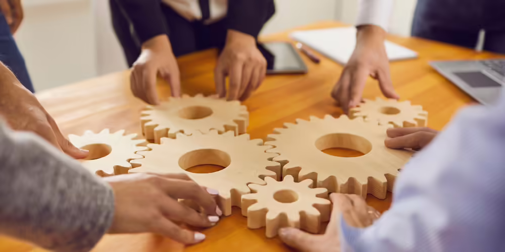 people working with cogs on a table