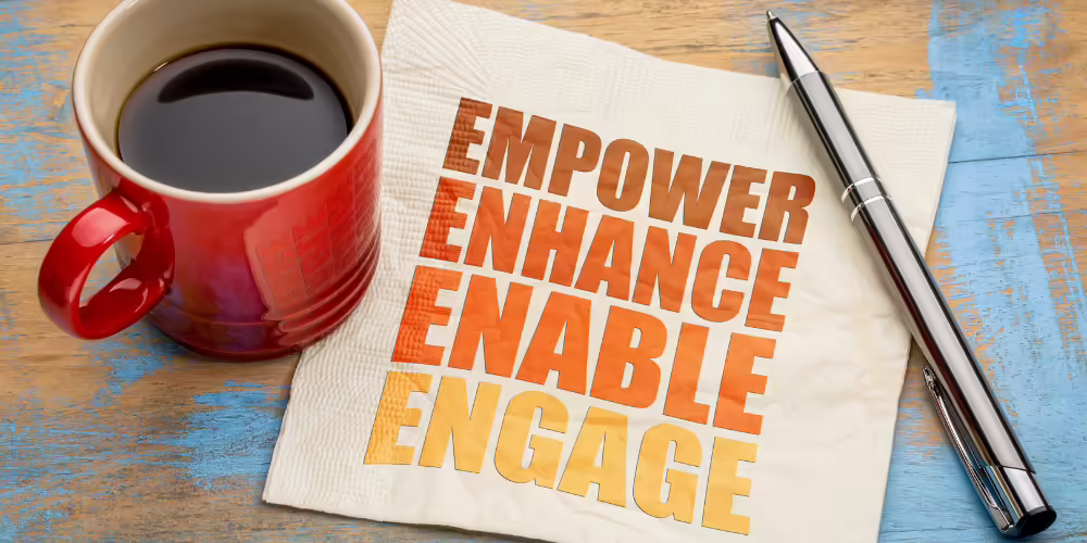 coffee cup on napkin with text "empower enhance enable engage"